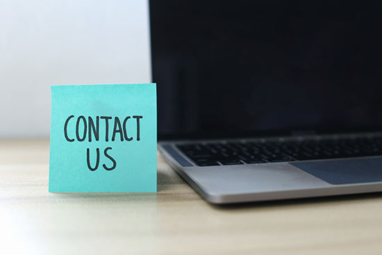 Contact us image of sticky note and laptop